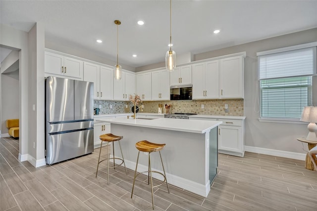 1554 Outback Rd W, Saint Cloud, FL 34771 - kitchen featuring freestanding refrigerator, tasteful backsplash, wood tiled floors, light countertops, and recessed lighting