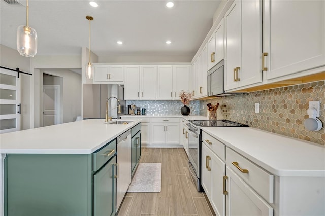 1554 Outback Rd W, Saint Cloud, FL 34771 - kitchen with appliances with stainless steel finishes, white cabinets, light countertops, hanging light fixtures, and recessed lighting