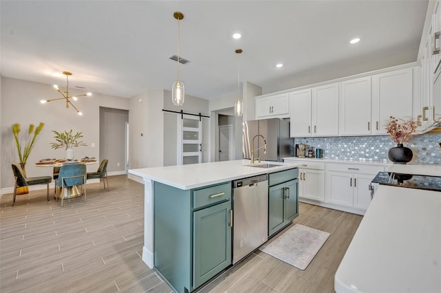 1554 Outback Rd W, Saint Cloud, FL 34771 - kitchen featuring stainless steel dishwasher, freestanding refrigerator, a barn door, light wood-style floors, and recessed lighting