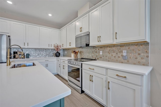 1554 Outback Rd W, Saint Cloud, FL 34771 - kitchen featuring appliances with stainless steel finishes, light countertops, white cabinets, and recessed lighting