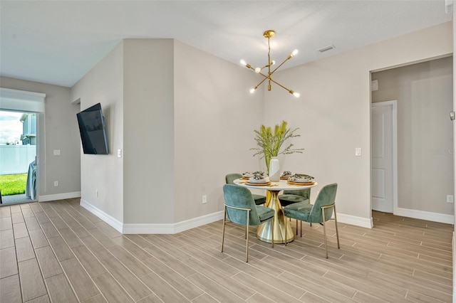 1554 Outback Rd W, Saint Cloud, FL 34771 - dining space with a chandelier and light wood-style flooring