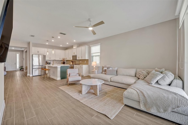1554 Outback Rd W, Saint Cloud, FL 34771 - living room with ceiling fan, light wood-style floors, and recessed lighting