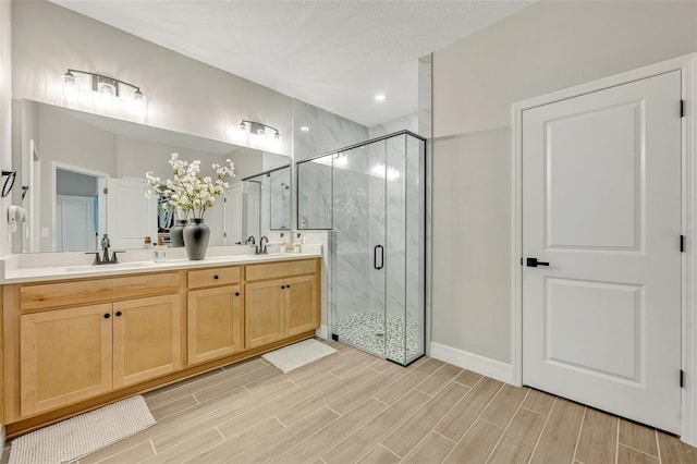 1554 Outback Rd W, Saint Cloud, FL 34771 - bathroom with a marble finish shower, double vanity, wood tiled floors, and recessed lighting