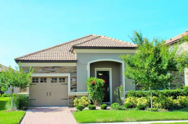 mediterranean / spanish house featuring a garage