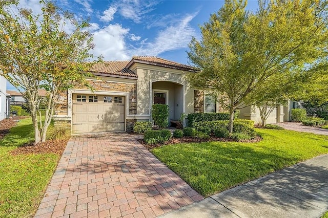 mediterranean / spanish house featuring a front lawn and a garage