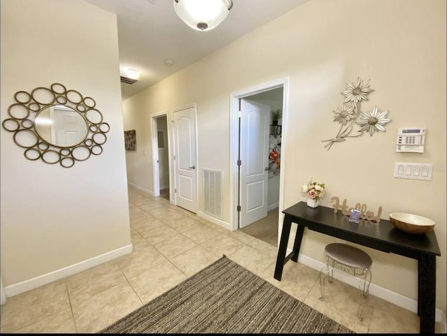 hall featuring light tile patterned flooring