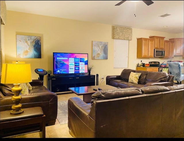 tiled living room with ceiling fan