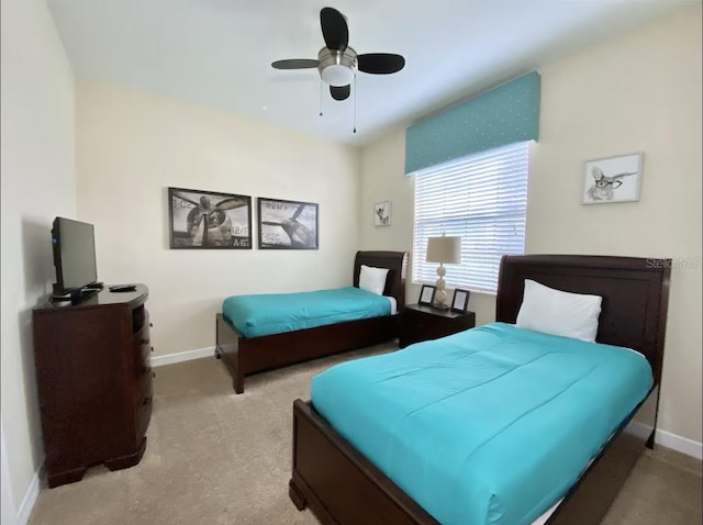 bedroom with light carpet and ceiling fan