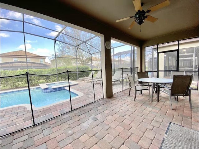 unfurnished sunroom with ceiling fan and a pool