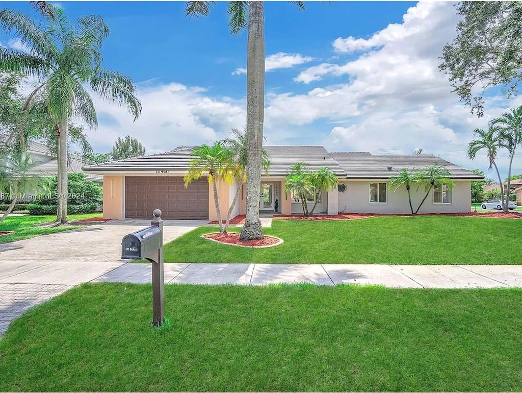 single story home with a front lawn and a garage