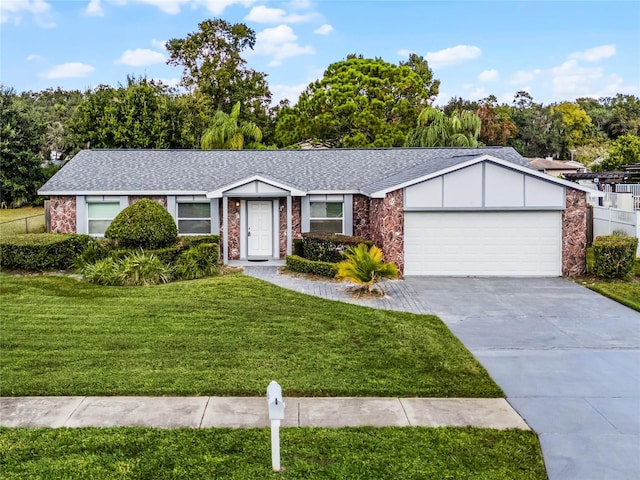 single story home with a garage and a front lawn