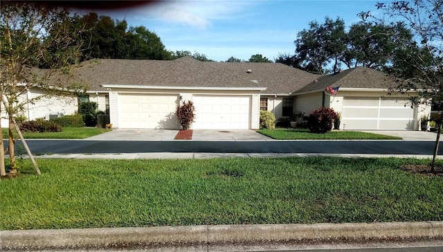 ranch-style house featuring a garage and a front lawn