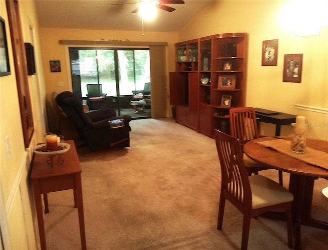 carpeted living room featuring vaulted ceiling and ceiling fan