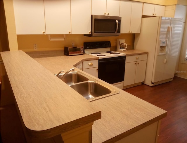 kitchen featuring dark hardwood / wood-style floors, white cabinetry, white appliances, and sink