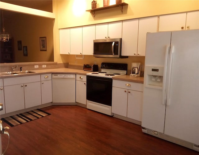 kitchen with sink, white cabinets, and white appliances