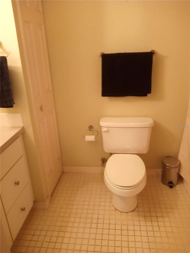 bathroom with tile patterned floors, vanity, and toilet