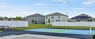 view of sport court featuring a yard