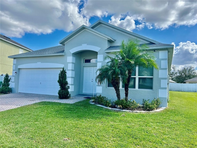 single story home featuring a front yard and a garage