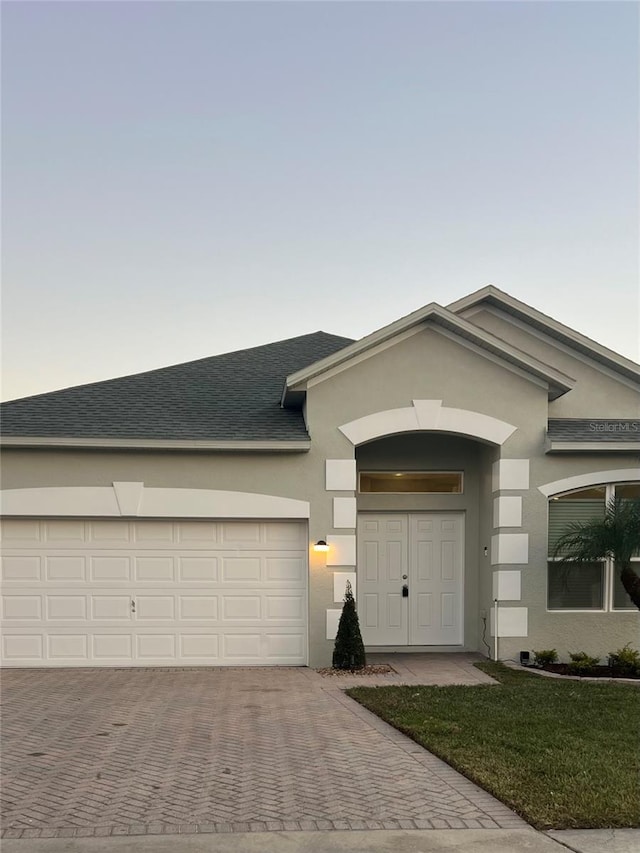 ranch-style home featuring a garage