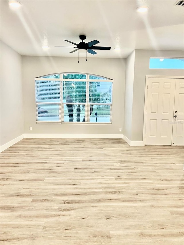 spare room featuring light wood-type flooring and ceiling fan