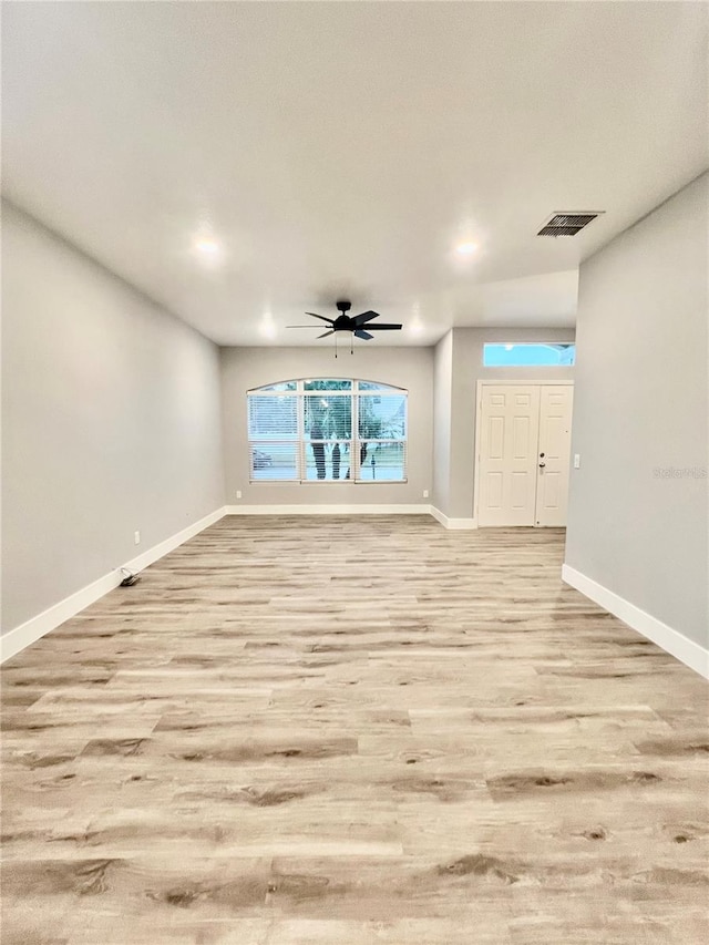 interior space with ceiling fan and light hardwood / wood-style flooring