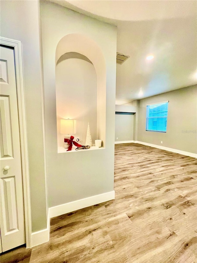 spare room featuring wood-type flooring