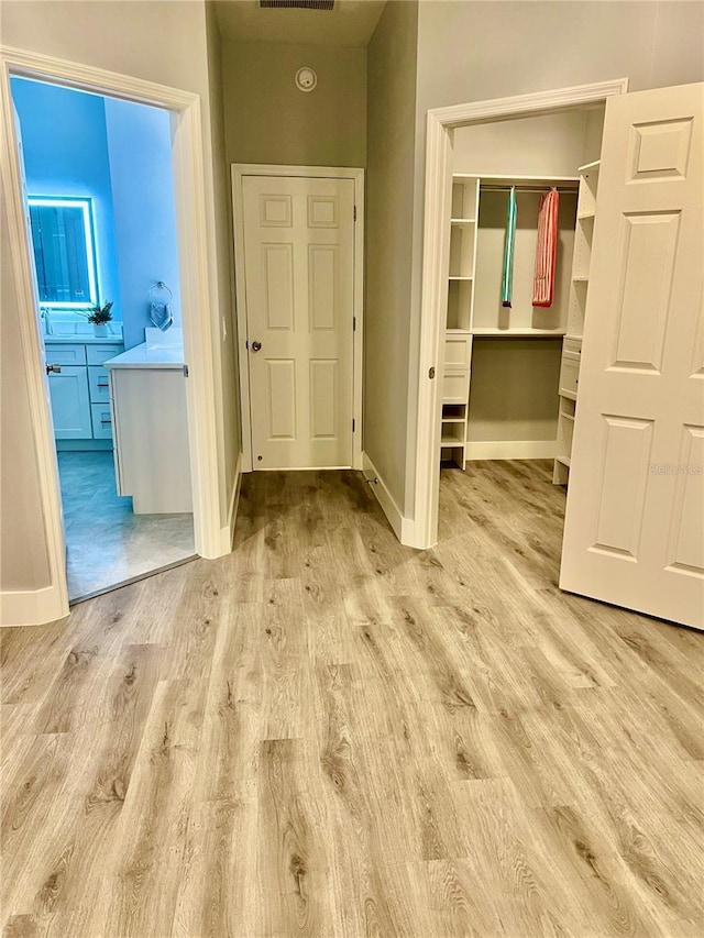 corridor with light hardwood / wood-style floors