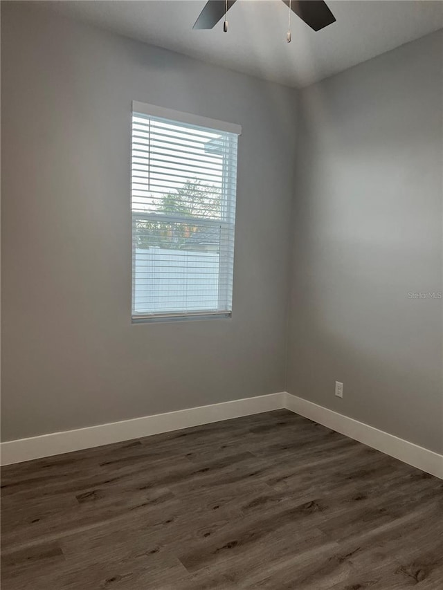 unfurnished room featuring ceiling fan and dark wood-type flooring