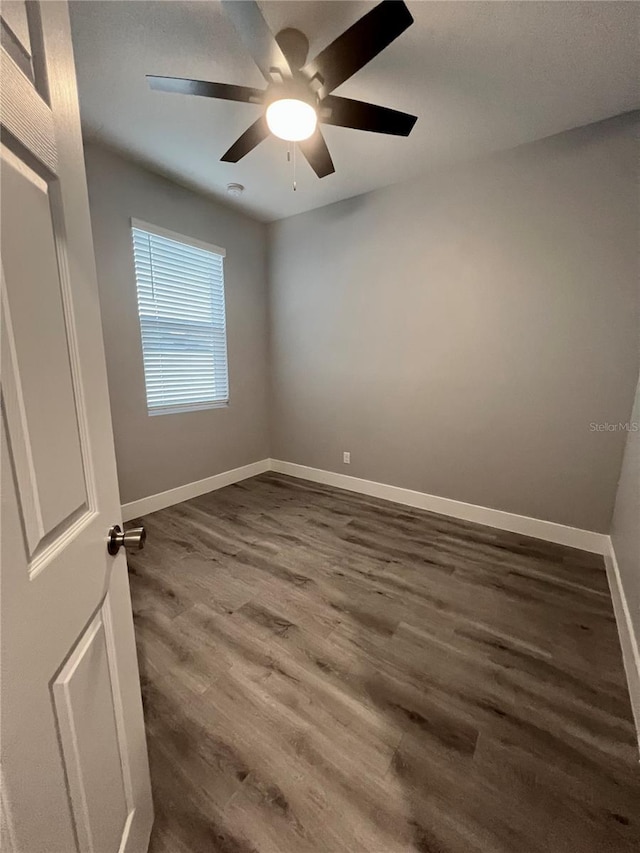 spare room with hardwood / wood-style floors and ceiling fan