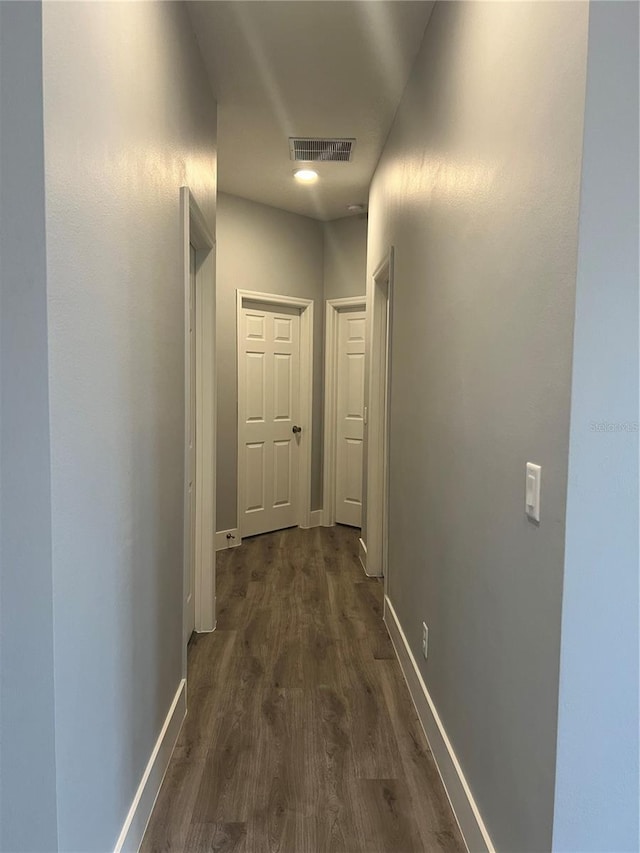 corridor with dark wood-type flooring