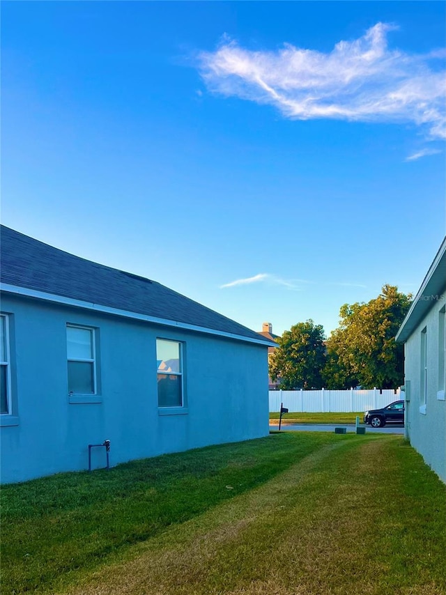 view of side of property with a lawn