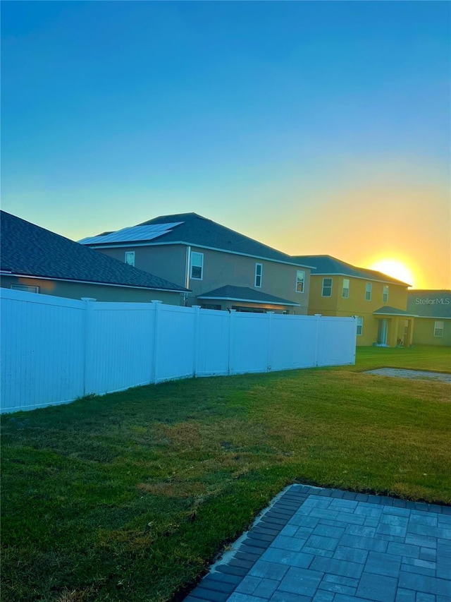 yard at dusk with a patio area