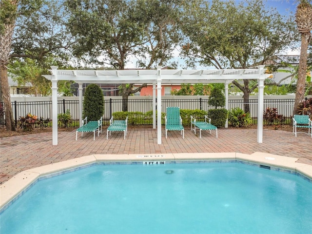 view of swimming pool with a fenced in pool, fence, a patio, and a pergola