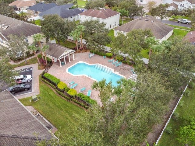 pool with a yard, a residential view, a patio, and fence