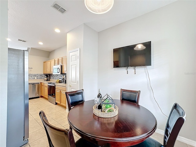 dining room with light tile patterned floors, baseboards, visible vents, and recessed lighting