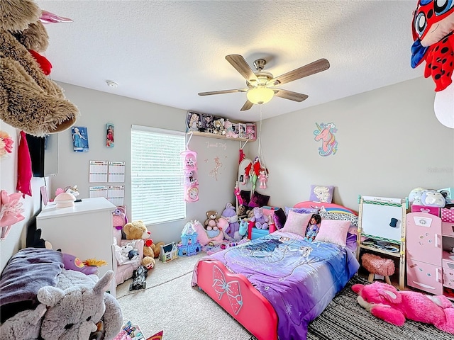 carpeted bedroom with ceiling fan and a textured ceiling