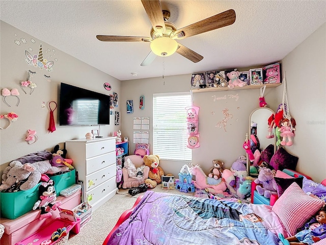 carpeted bedroom with a ceiling fan and a textured ceiling