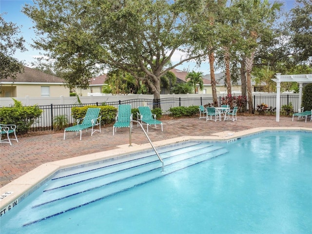 community pool featuring a patio area and fence