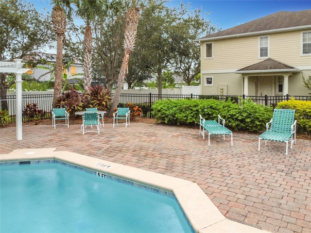 community pool featuring a patio and fence