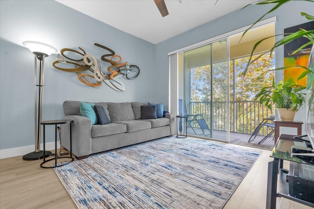 living room with hardwood / wood-style flooring and ceiling fan