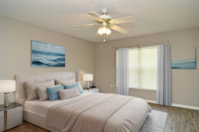 bedroom with wood-type flooring and ceiling fan