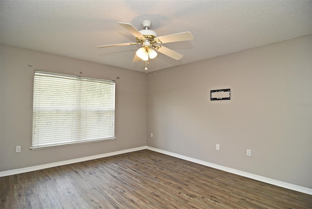 unfurnished room with ceiling fan, a textured ceiling, and dark hardwood / wood-style flooring