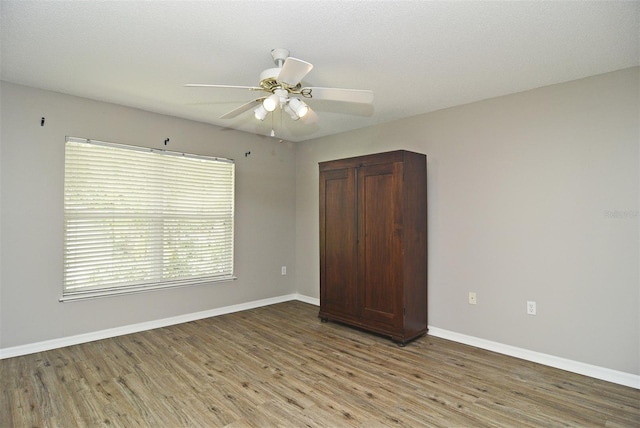 unfurnished bedroom featuring a textured ceiling, light hardwood / wood-style flooring, and ceiling fan