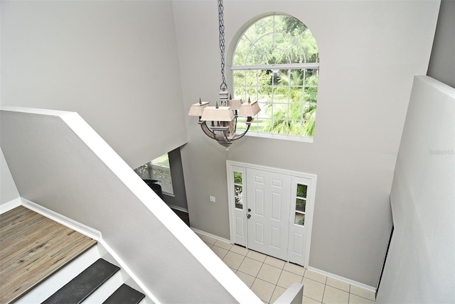 tiled foyer with a high ceiling