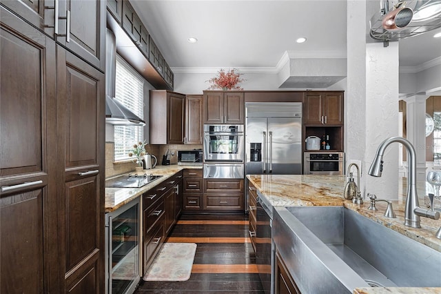 kitchen featuring crown molding, wine cooler, appliances with stainless steel finishes, dark hardwood / wood-style floors, and sink