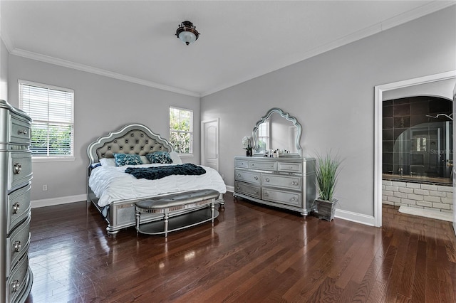 bedroom featuring dark hardwood / wood-style flooring, crown molding, and connected bathroom