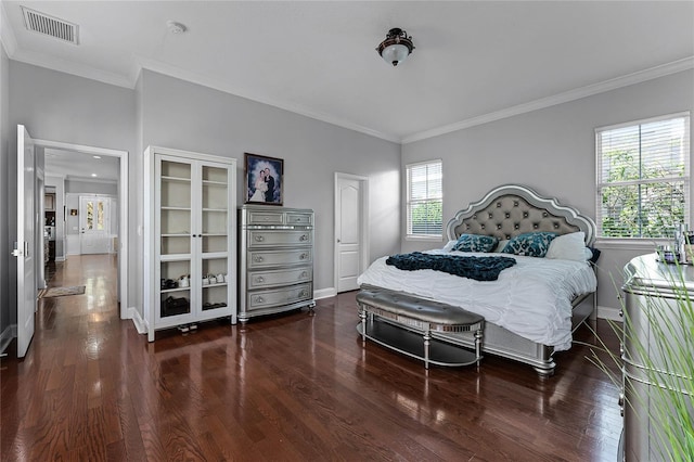 bedroom featuring dark hardwood / wood-style floors, multiple windows, and ornamental molding