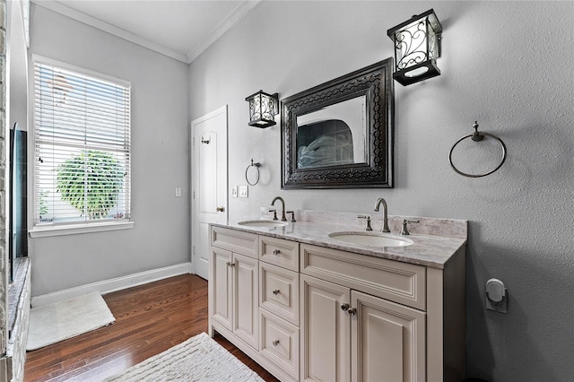 bathroom featuring wood-type flooring, vanity, and ornamental molding