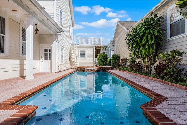 view of swimming pool with a patio and an in ground hot tub