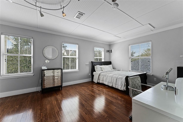 bedroom featuring ornamental molding, dark wood-type flooring, and multiple windows